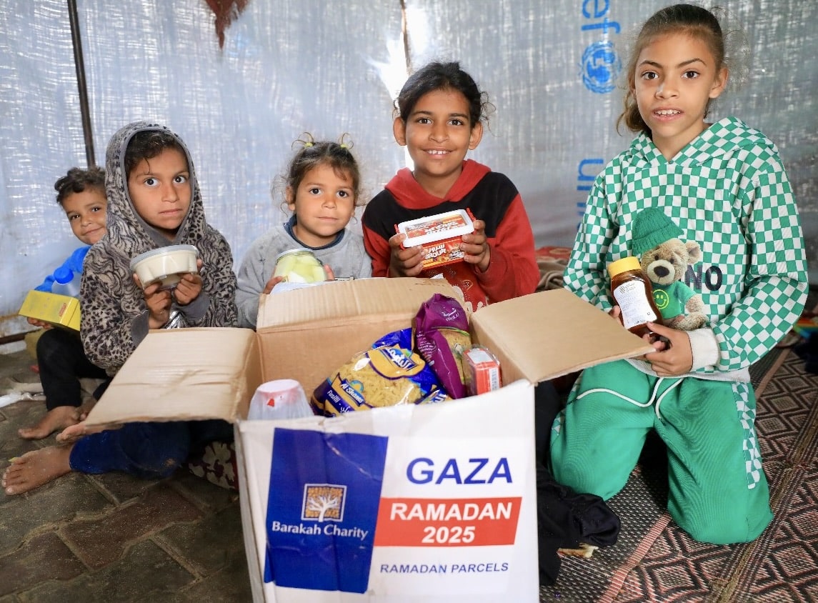 Happy children opening a Ramadan parcel filled with food